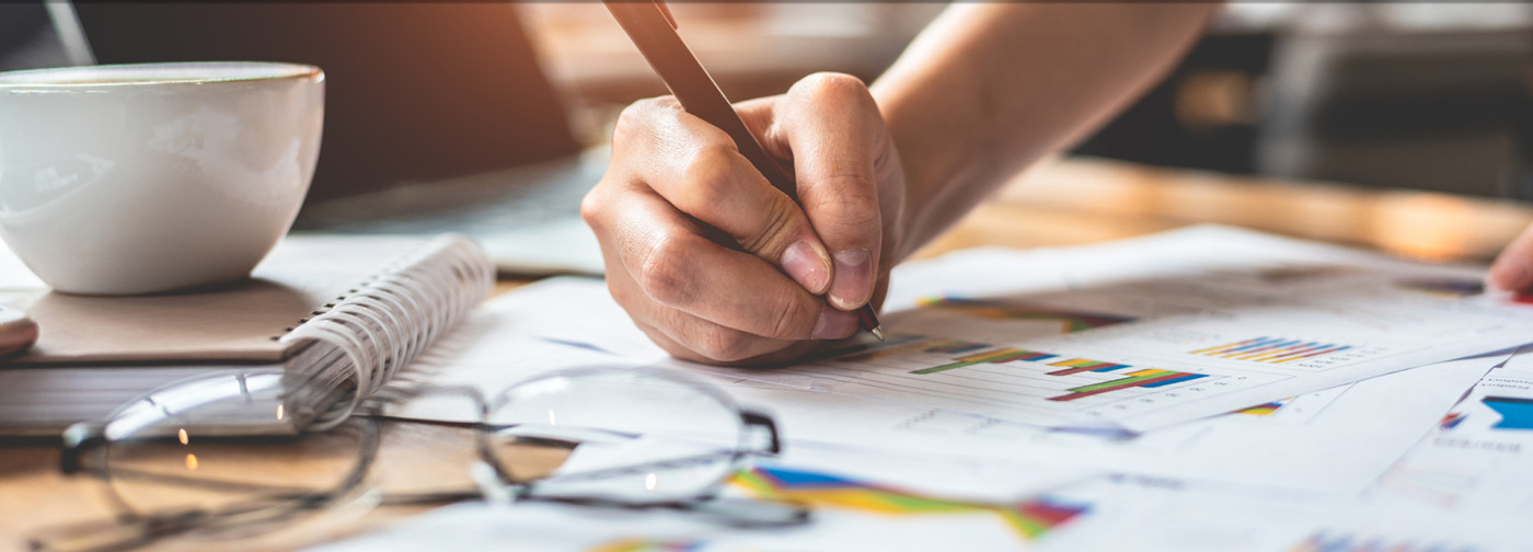 Bookkeeper writing on paper like at Complete Bookkeeping by Andrea